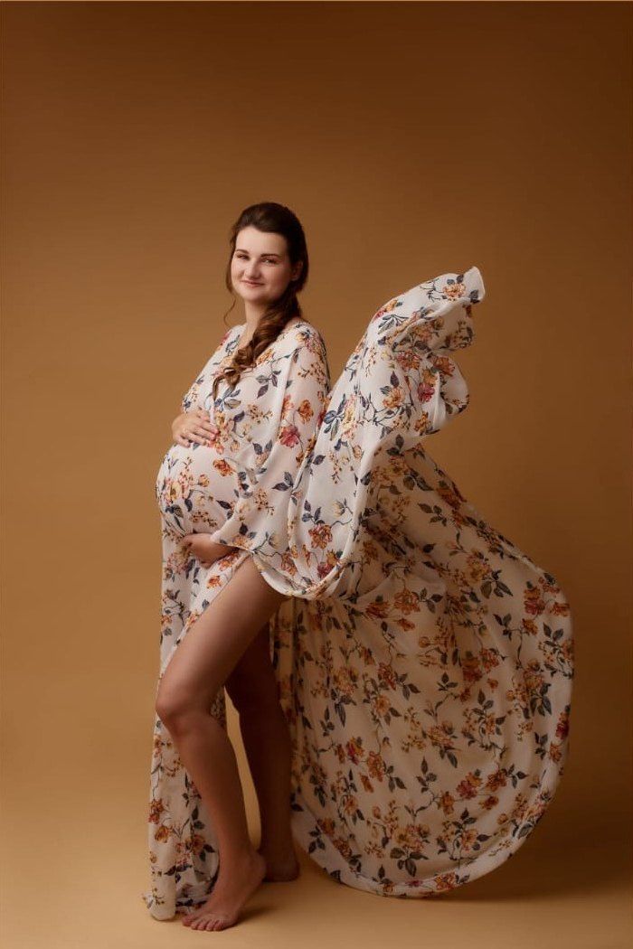 Maternity studio portrait after editing, with a clean extended backdrop