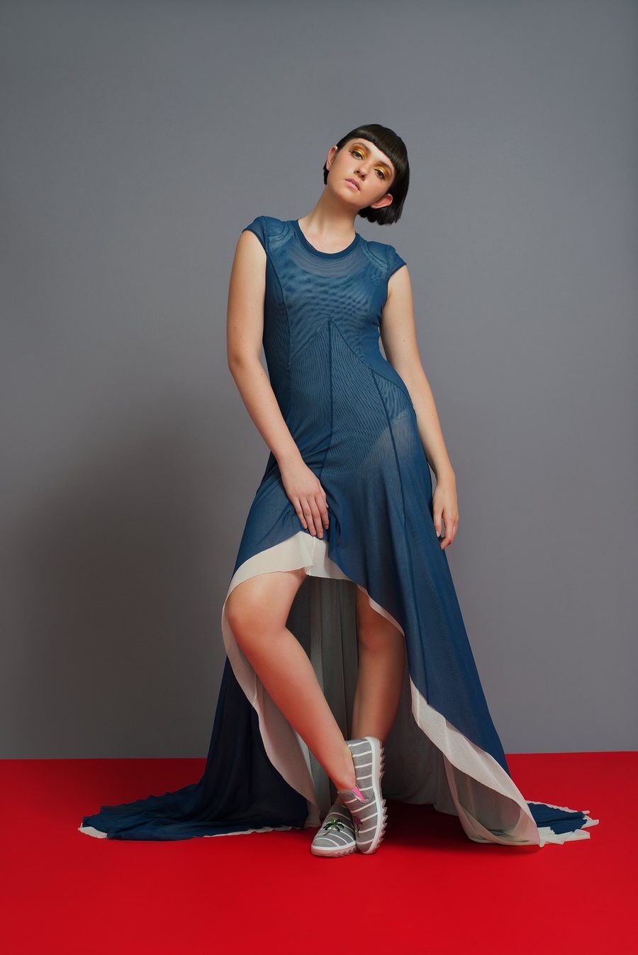 Model in a blue high-low dress after fashion retouching